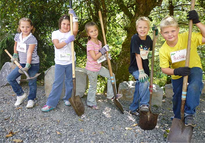 Group of young program participants with shovels