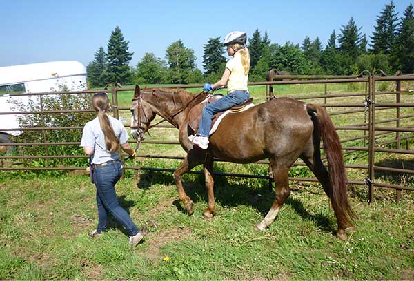 OMF Inc. Student Leading Horse with Second OMF Inc. Student Riding