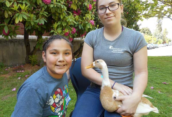 Two OMF Inc. Students Sitting with Duck